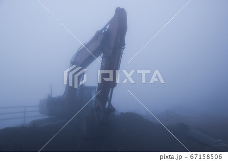 Foggy day and excavator Foggy day and excavator 67158506