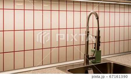 Kitchen made of fine tiles with red lines.  67161390