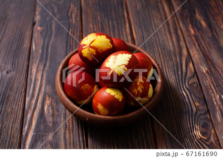 Wooden bowl with plant pattern colored eggs Wooden bowl with plant pattern colored eggs 67161690