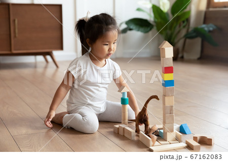 Small asian baby girl playing with cubes alone at home. 67162083