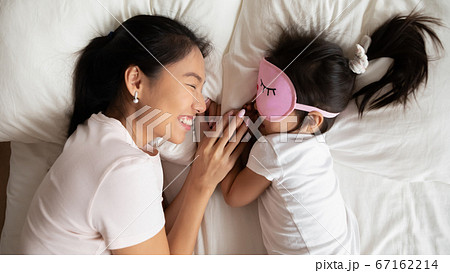 Smiling caring asian ethnic mommy watching little baby sleeping. Smiling caring asian ethnic mommy watching little baby sleeping. 67162214