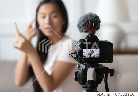 Close up professional camera recording young vietnamese woman. 67162216