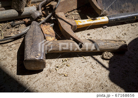 Rusty tools lying on an old dusty workbench Rusty tools lying on an old dusty workbench 67168656