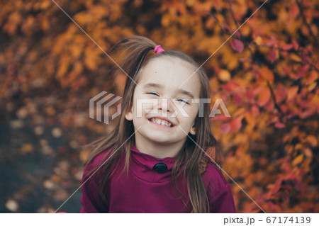 a small child in a warm suit walks in the woods. autumn park. The concept of children's fashion, accessories, outdoor walks a small child in a warm suit walks in the woods. autumn park. The concept of children's fashion, accessories, outdoor walks 67174139