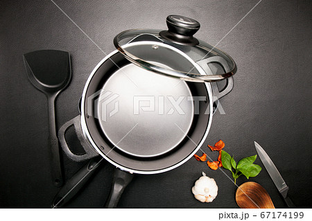 Top view frying pan and pot on black table. 67174199