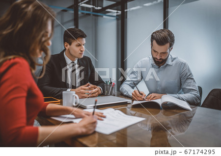 Spouses writing a divorce request with their lawyer Spouses writing a divorce request with their lawyer 67174295