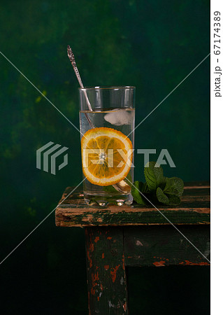 Glass with a drink in a glass on a green 67174389