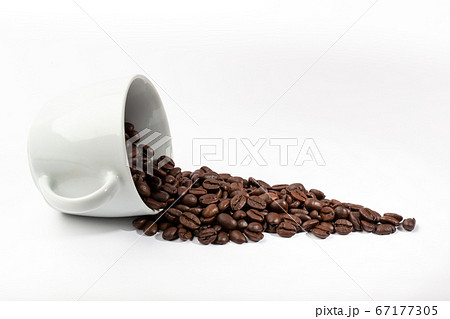 White cup with coffee beans on white background 67177305