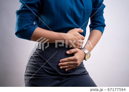 Closeup shot of woman was sick with stomach ache Closeup shot of woman was sick with stomach ache 67177564