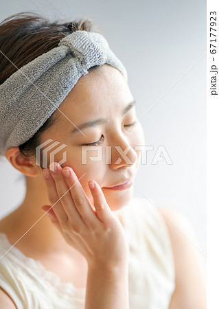 フェイスケアをするヘアバンドをした30代女性 67177923