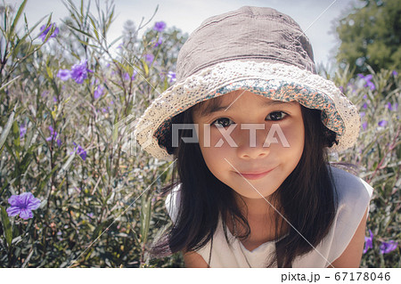 close up of Asian little girl a pose in the park close up of Asian little girl a pose in the park 67178046
