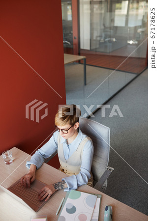 Tattooed Young Woman at Workplace High Angle Tattooed Young Woman at Workplace High Angle 67178625