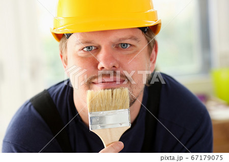 Arm of smiling worker hold brush portrait 67179075