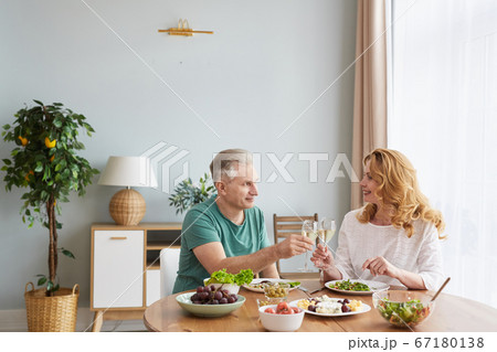 Mature Couple Enjoying Dinner at Home Mature Couple Enjoying Dinner at Home 67180138