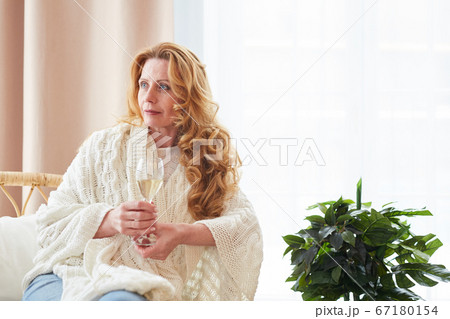 Beautiful Mature Woman Holding Champagne Glass at Home Beautiful Mature Woman Holding Champagne Glass at Home 67180154