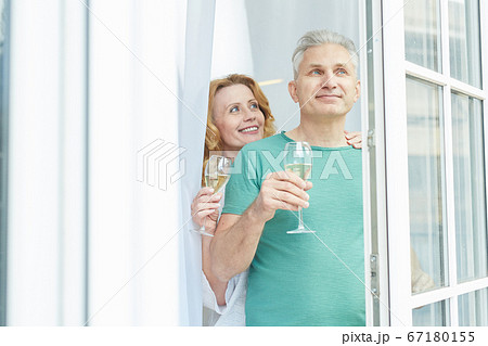 Mature Couple Looking Out of Window in Hotel 67180155