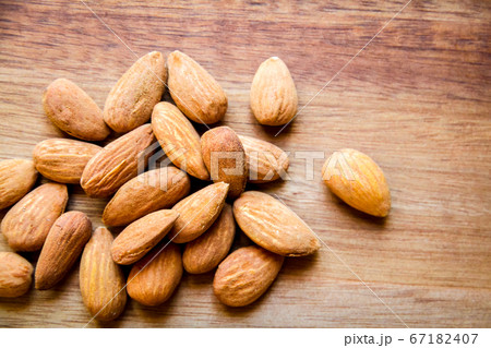 Almonds on a wooden cutting board Almonds on a wooden cutting board 67182407