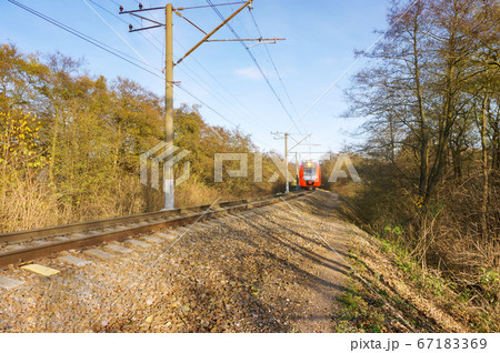 railway tracks go into the distance, the train at 67183369
