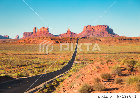 Classic highway view in Monument Valley at sunset, Utah, USA Classic highway view in Monument Valley at sunset, Utah, USA 67183641