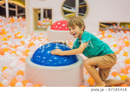 The boy has fun in an indoor playground The boy has fun in an indoor playground 67185418