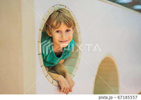 The boy has fun in an indoor playground The boy has fun in an indoor playground 67185557