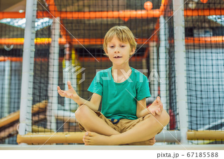 The boy has fun in an indoor playground The boy has fun in an indoor playground 67185588