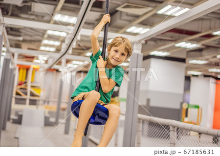 The boy has fun in an indoor playground The boy has fun in an indoor playground 67185631