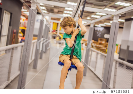 The boy has fun in an indoor playground The boy has fun in an indoor playground 67185681