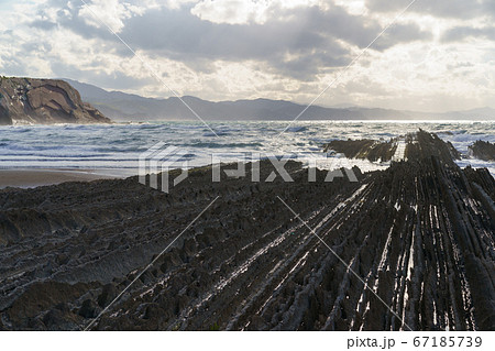 Breathtaking sescape in Basque Autonomous Community / country in summer cloudy day. Wide Atlantic ocean coast at low tide in Bay of Biscay. Charming Zumaia Itzurun beach. High resolution image. Breathtaking sescape in Basque Autonomous Community / country in summer cloudy day. Wide Atlantic ocean coast at low tide in Bay of Biscay. Charming Zumaia Itzurun beach. High resolution image. 67185739