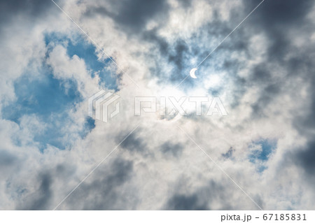 Solar Eclipse in blue sky among the clouds 67185831