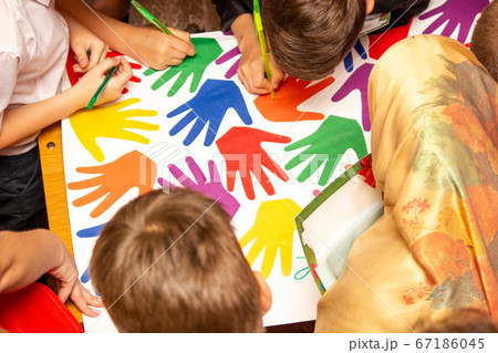 Children draw on a poster, a view from the top 67186045