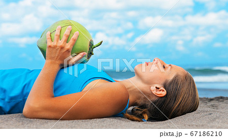 Woman fitness exercise with green coconuts on Woman fitness exercise with green coconuts on 67186210