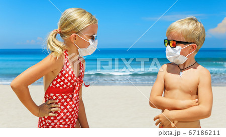 Two young children wearing sunglasses, protective Two young children wearing sunglasses, protective 67186211
