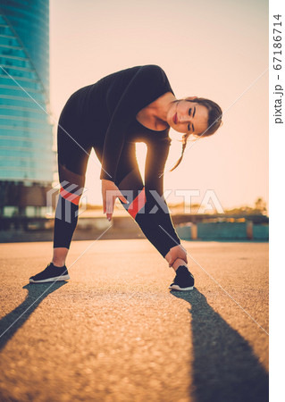 Sporty Brunette Girl Makes Slow Stretching After Dance Lessons. Sporty Brunette Girl Makes Slow Stretching After Dance Lessons. 67186714