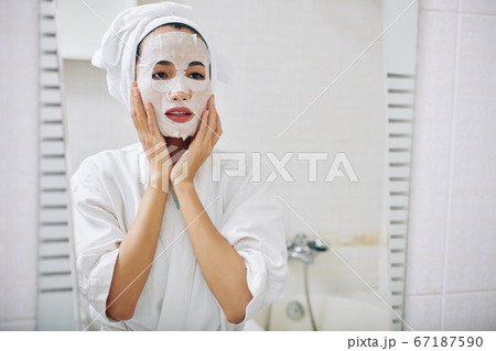 Young woman with sheet mask 67187590