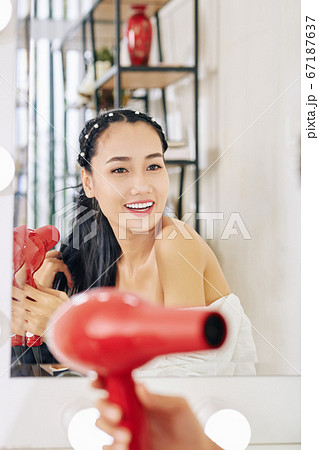 Woman blowing out hair 67187637
