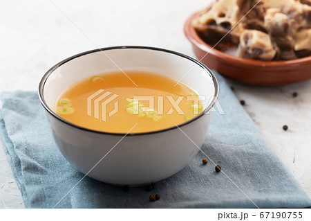Homemade Beef Bone Broth in a bowl on a gray 67190755