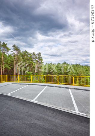 Empty highway rest area by a forest. 67193547