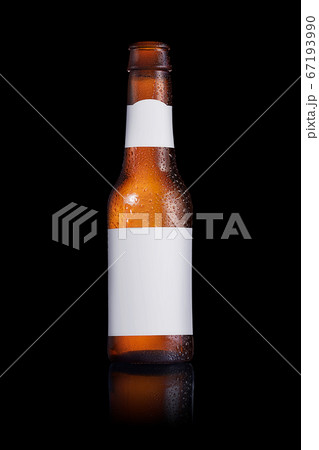 Beer bottle with a blank label on a black Beer bottle with a blank label on a black 67193990