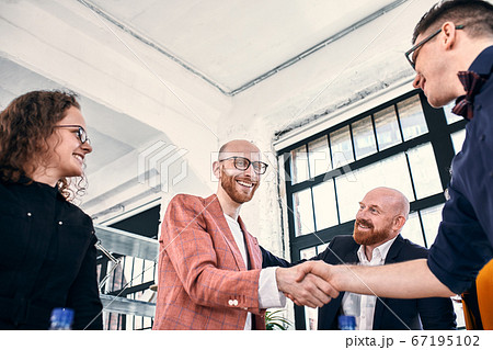 Business handshake at meeting or negotiation in the office. Partners are satisfied because signing contract or financial papers Business handshake at meeting or negotiation in the office. Partners are satisfied because signing contract or financial papers 67195102