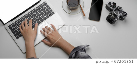 Female working on simple workspace with mock-up Female working on simple workspace with mock-up 67201351