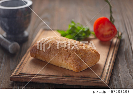 Ciabatta vegetables greens on kitchen board, close up Ciabatta vegetables greens on kitchen board, close up 67203193