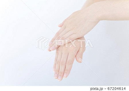 ハンドクリームを塗る女性の手元 67204614