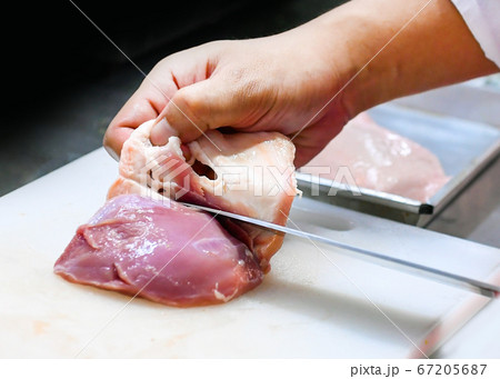 chef cutting Chicken fillet breast on board, chef 67205687