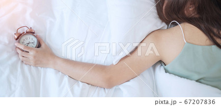 alarm clock and asian woman hand stop time in bed alarm clock and asian woman hand stop time in bed 67207836