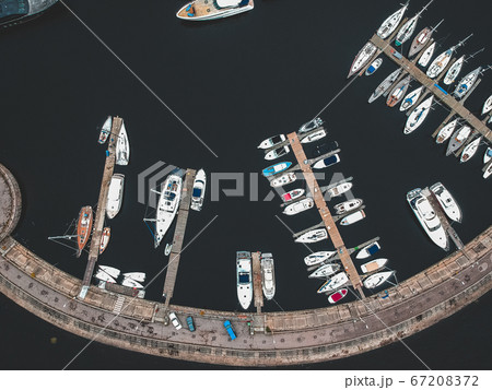 Aerialphoto yacht club with a breakwater. Yachts, motor boats, sailboats, berths, piers. Aerialphoto yacht club with a breakwater. Yachts, motor boats, sailboats, berths, piers. 67208372