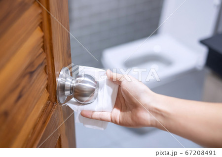 Woman hand cleaning toilet doorknob by wet wipe Woman hand cleaning toilet doorknob by wet wipe 67208491