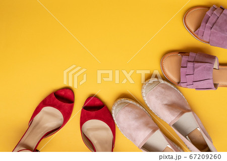 Trendy collection of women shoes on a yellow Trendy collection of women shoes on a yellow 67209260