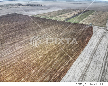 Tractor plows a field, aerial view.  67210112