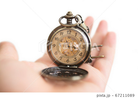 Men hands hold a pocket watch and a white background. Men hands hold a pocket watch and a white background. 67211089